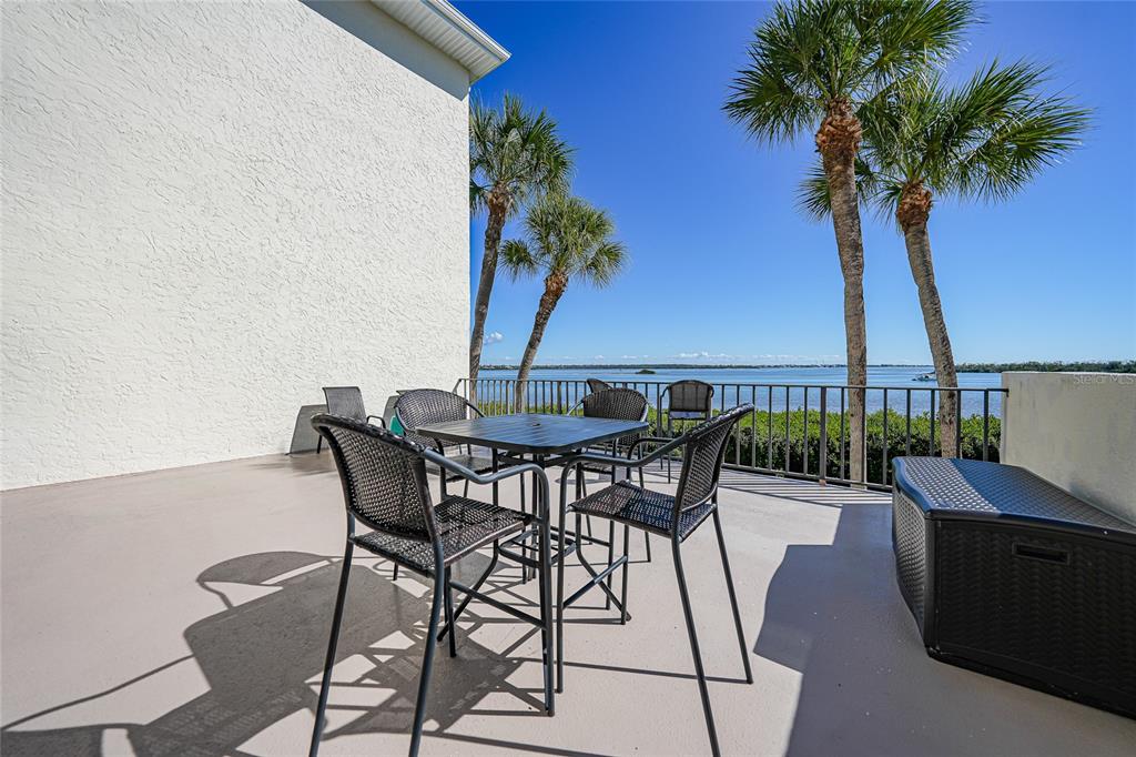 1591 Beach Road, Unit 202 Englewood, FL 34223 - Photo 29 of 46 a view of a patio with furniture and a potted plant