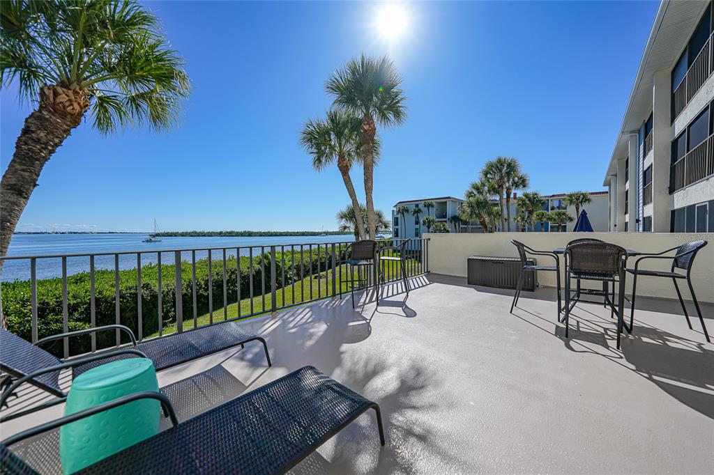 1591 Beach Road, Unit 202 Englewood, FL 34223 - Photo 30 of 46 a view of a patio with a table and chairs
