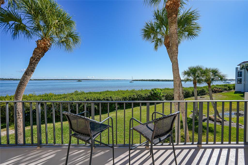 1591 Beach Road, Unit 202 Englewood, FL 34223 - Photo 31 of 46 a view of a chair and table on the deck
