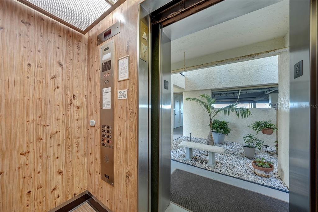 1591 Beach Road, Unit 202 Englewood, FL 34223 - Photo 33 of 46 a bathroom with a glass shower door and a mirror