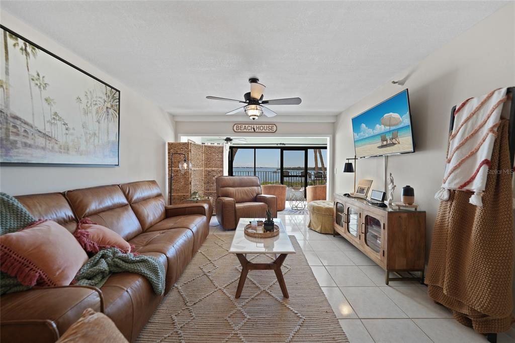 1591 Beach Road, Unit 202 Englewood, FL 34223 - Photo 4 of 46 a living room with furniture a fireplace and a flat screen tv