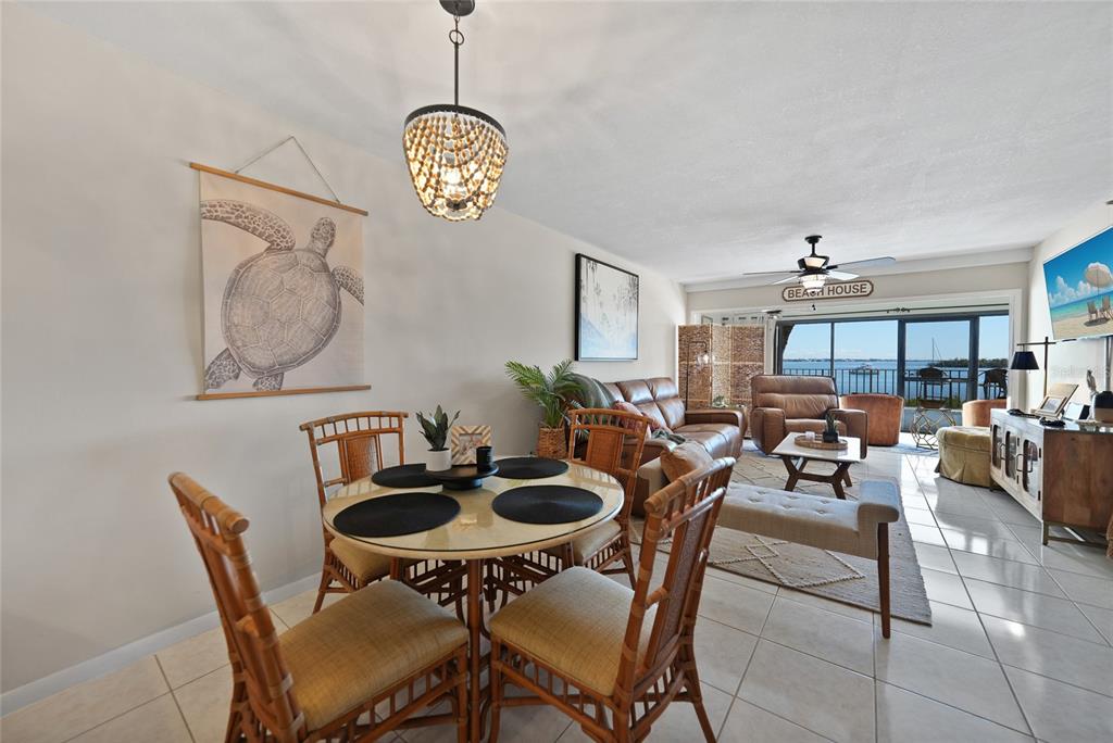 1591 Beach Road, Unit 202 Englewood, FL 34223 - Photo 6 of 46 a view of a dining room with furniture and chandelier