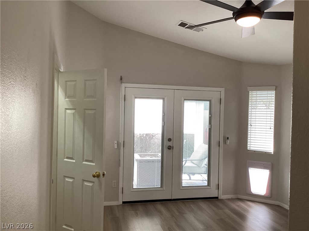 2135 Hidden Ranch Terrace Henderson, NV 89052 - Photo 21 of 27 Vast French doors open to outdoor space, complementing the wood-look flooring and soaring vaulted ceilings.