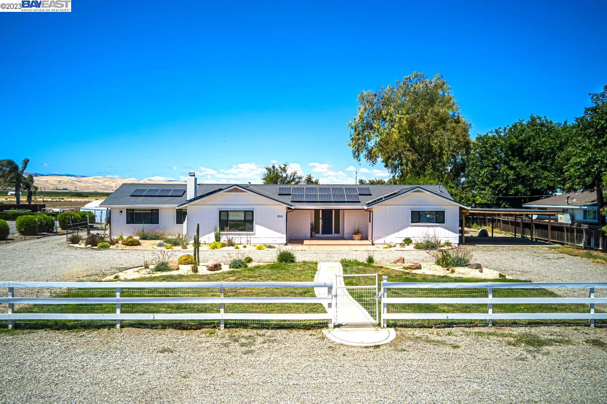32329 South Bird Road Tracy, CA 95304 - Photo 1 of 1 a front view of a house with garden
