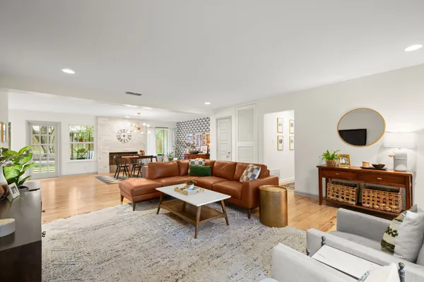 a living room with furniture a rug and a large window