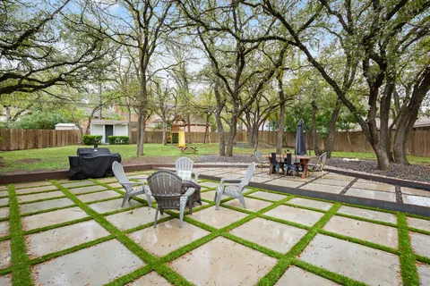 a view of a swimming pool with a patio and a garden