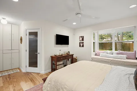 a bedroom with a bed and a large window
