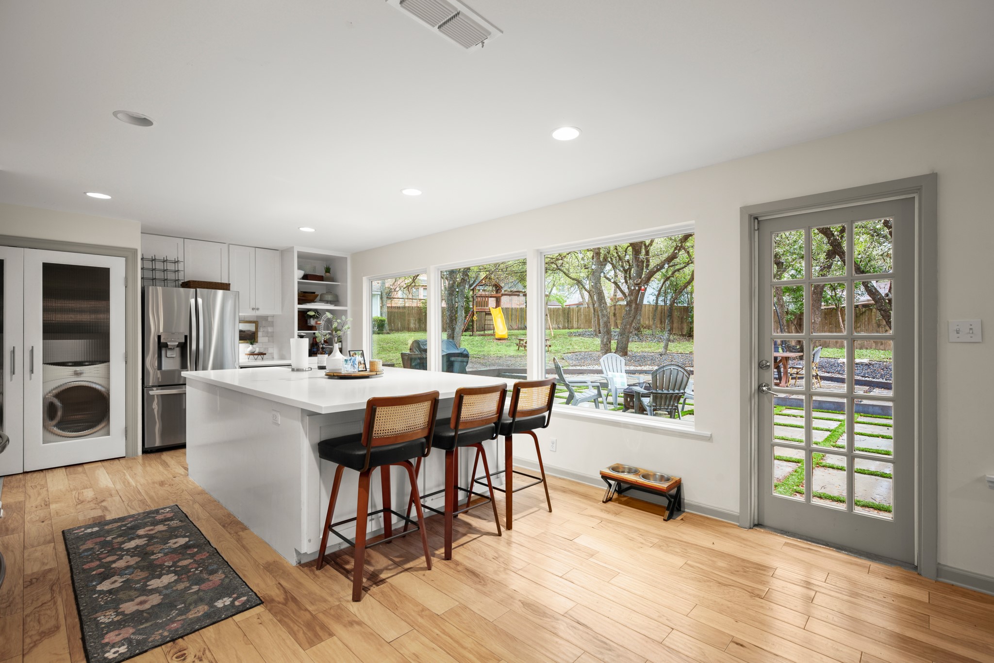 8600 Azalea Trail Austin, TX 78759 - Photo 8 of 26 a living room with furniture and large windows with wooden floor