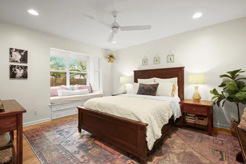 a spacious bedroom with a bed and a window