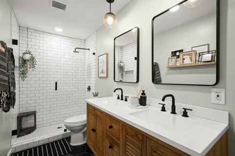 a bathroom with a sink mirror and toilet