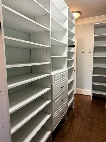 a view of walk in closet with empty racks