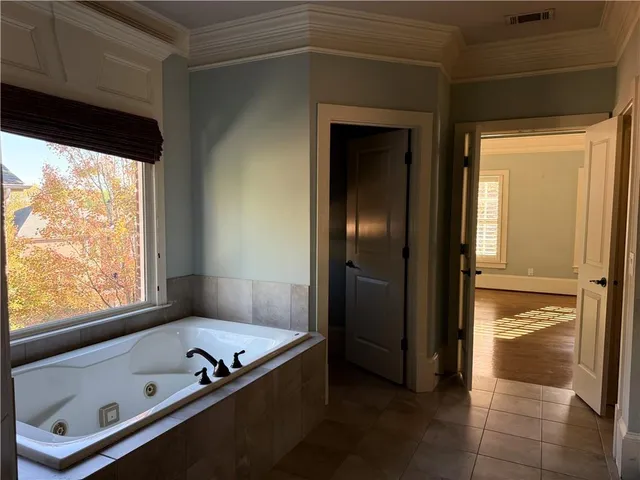 a bathroom with a tub and a shower