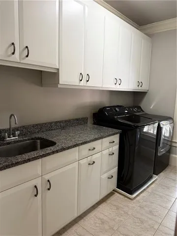a kitchen with granite countertop white cabinets and a stove