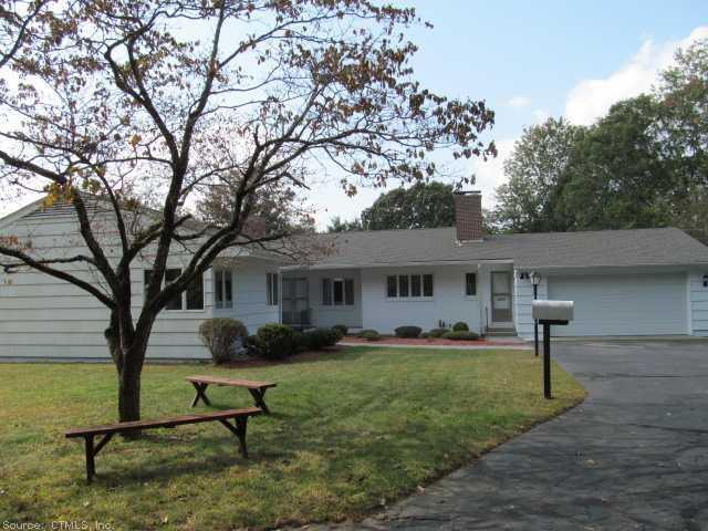 a view of a house with backyard and a tree