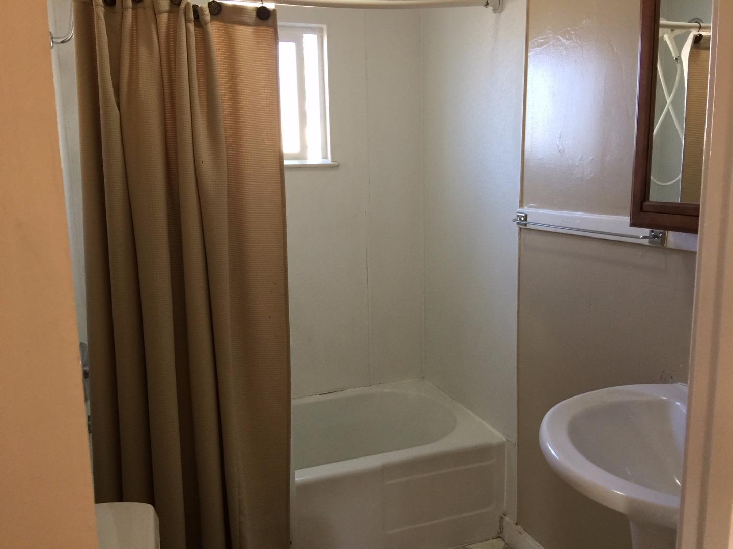 333 Brighton Road Pacifica, CA 94044 - Photo 4 of 9 a bathroom with a bathtub and shower