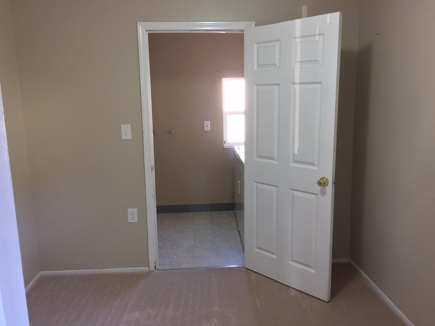 333 Brighton Road Pacifica, CA 94044 - Photo 5 of 9 an empty room with closet and wooden door