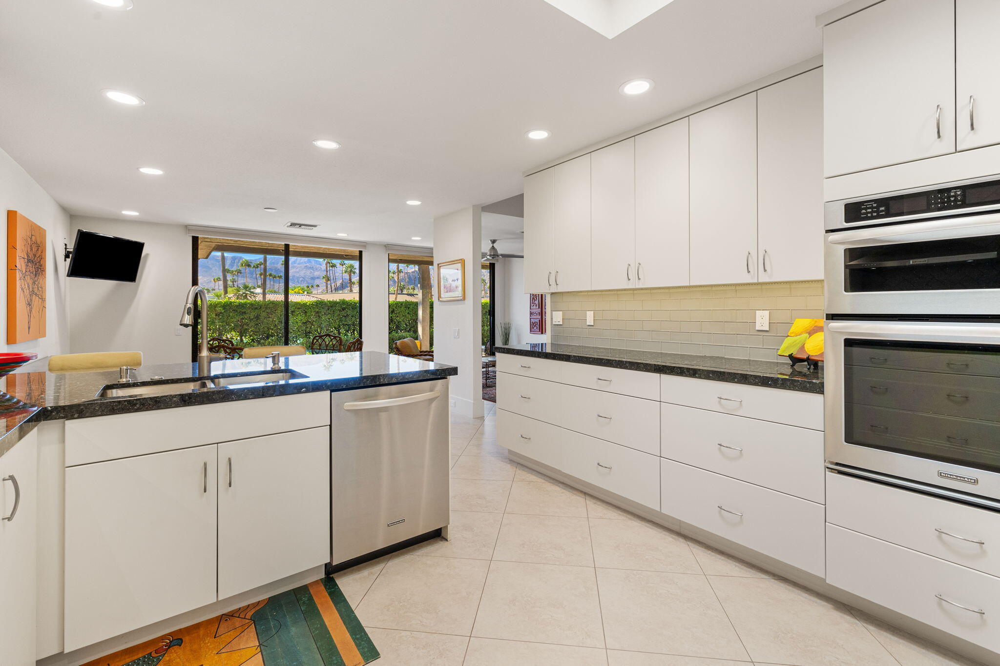 15 Reed Court Rancho Mirage, CA 92270 - Photo 24 of 53 a kitchen with granite countertop white cabinets and white appliances