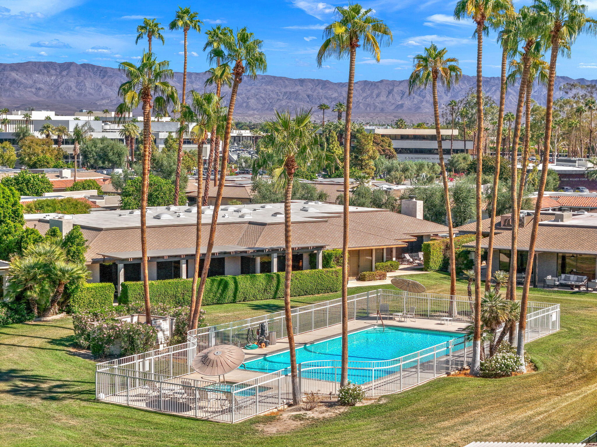 15 Reed Court Rancho Mirage, CA 92270 - Photo 53 of 53 a view of a swimming pool with a lawn chairs under an umbrella