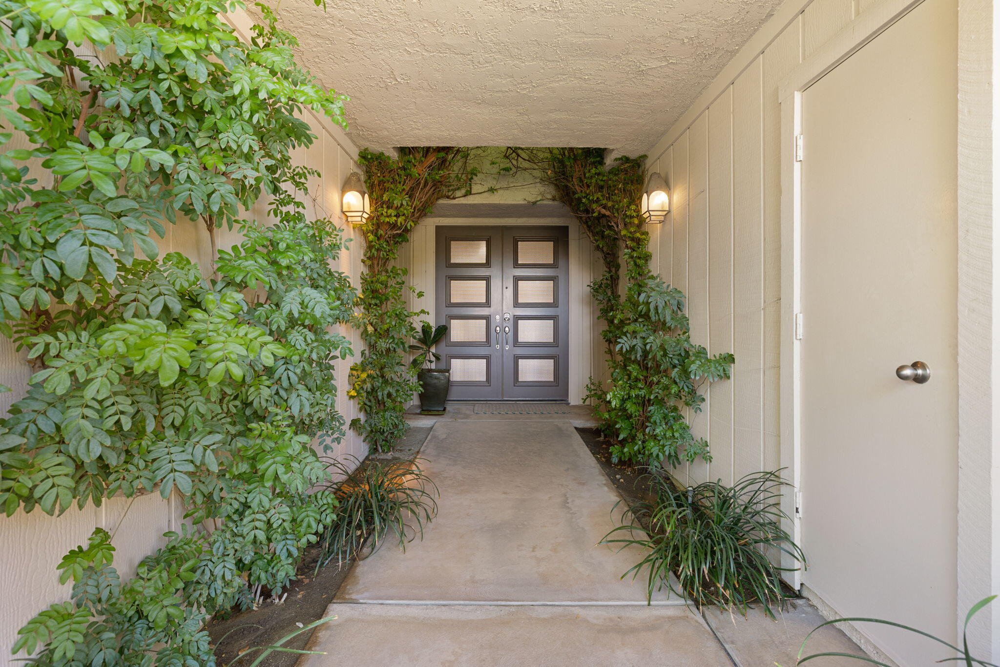 15 Reed Court Rancho Mirage, CA 92270 - Photo 6 of 53 an entrance to house with yard and green space