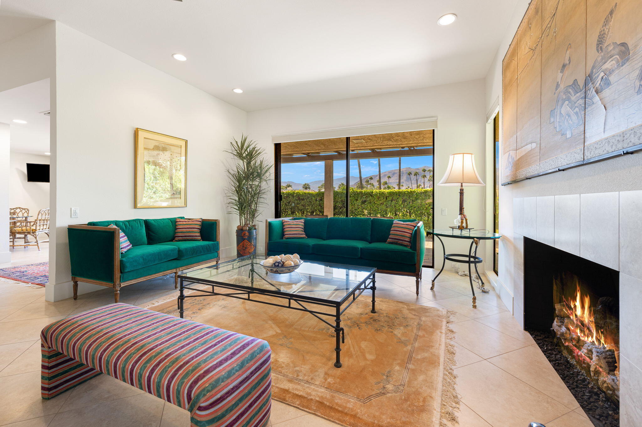 15 Reed Court Rancho Mirage, CA 92270 - Photo 8 of 53 a living room with furniture a fireplace and a large window