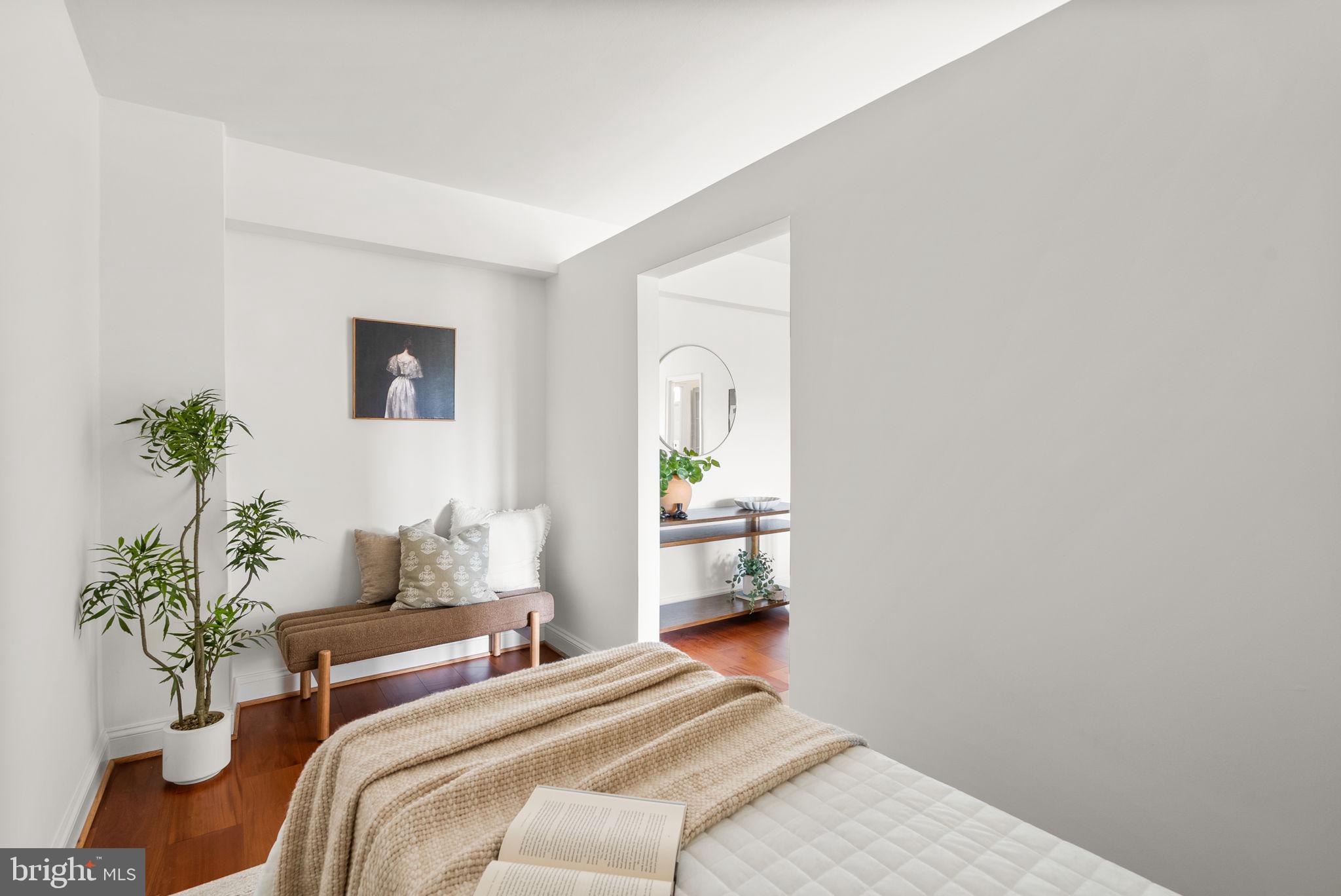 2500 Q Street Northwest, Unit 524 Washington, DC 20007 - Photo 18 of 50 a bedroom with a bed and a potted plant
