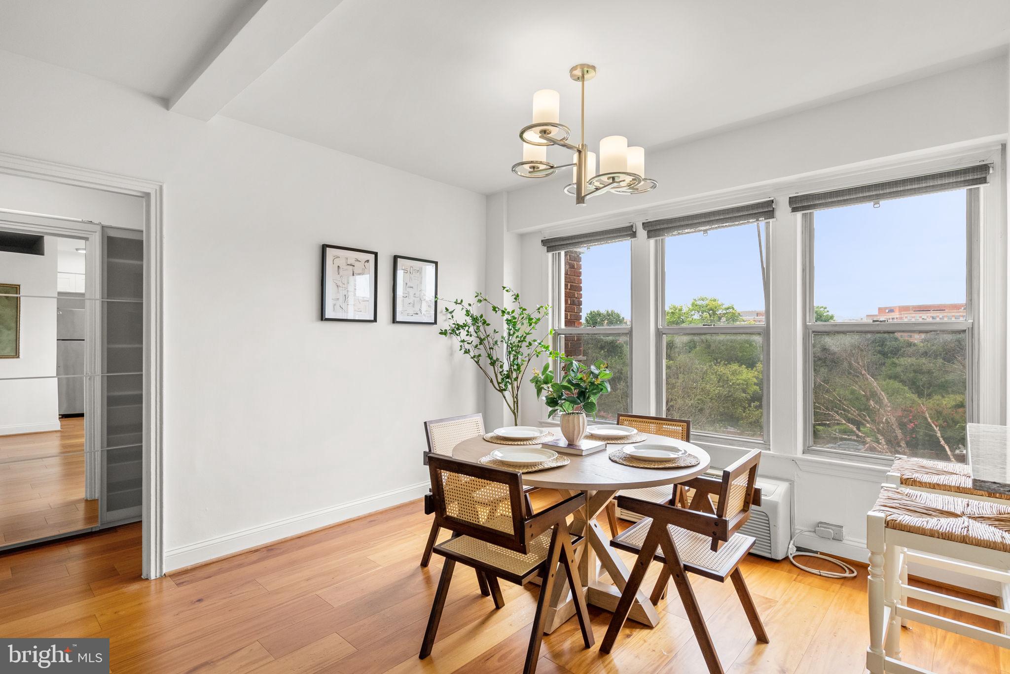 2500 Q Street Northwest, Unit 524 Washington, DC 20007 - Photo 21 of 50 a dining room with furniture a chandelier and wooden floor