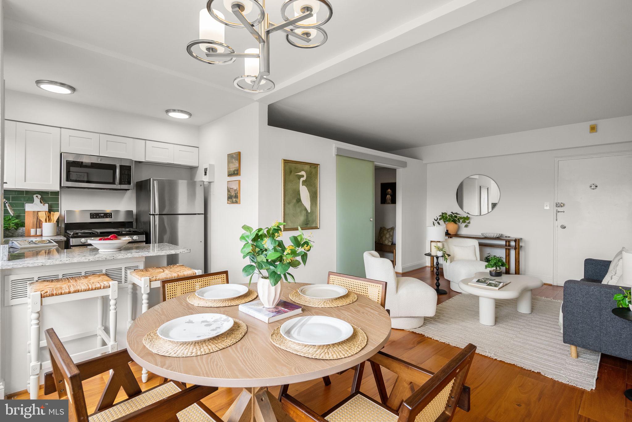 2500 Q Street Northwest, Unit 524 Washington, DC 20007 - Photo 23 of 50 a dining room with wooden floor a chandelier a wooden table and chairs