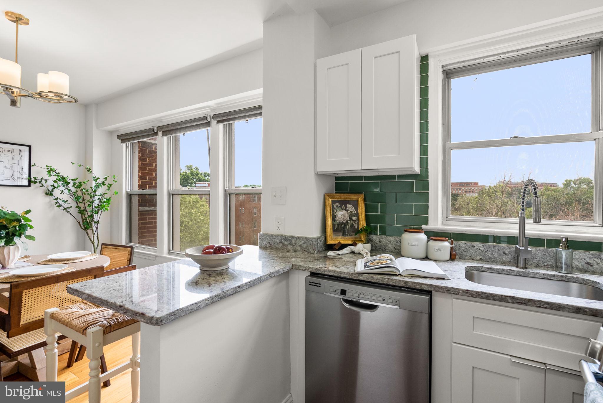 2500 Q Street Northwest, Unit 524 Washington, DC 20007 - Photo 27 of 50 a kitchen with granite countertop a sink and a window