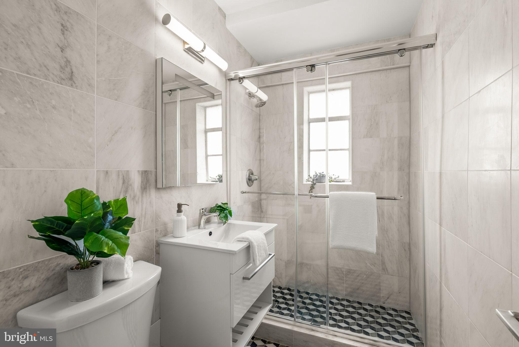2500 Q Street Northwest, Unit 524 Washington, DC 20007 - Photo 29 of 50 a bathroom with a sink a window and a shower