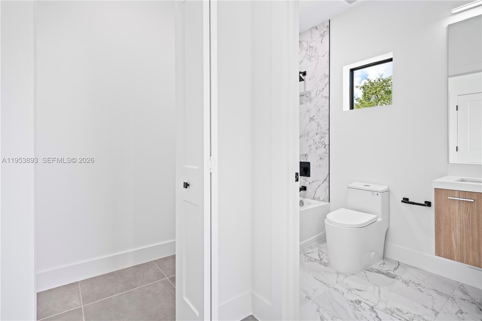 526 Southwest 2nd Street, Unit 5 Miami, FL 33130 - Photo 21 of 27 a bathroom with a toilet sink and shower