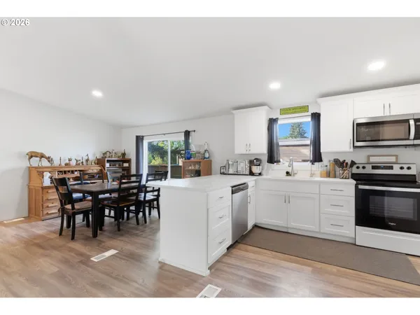 a kitchen with refrigerator and cabinets