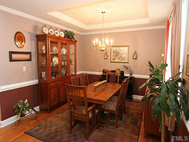 3805 Evander Way Raleigh, NC 27613 - Photo 3 of 23 The formal dining room features a trey ceiling and chair rall. Dining Room