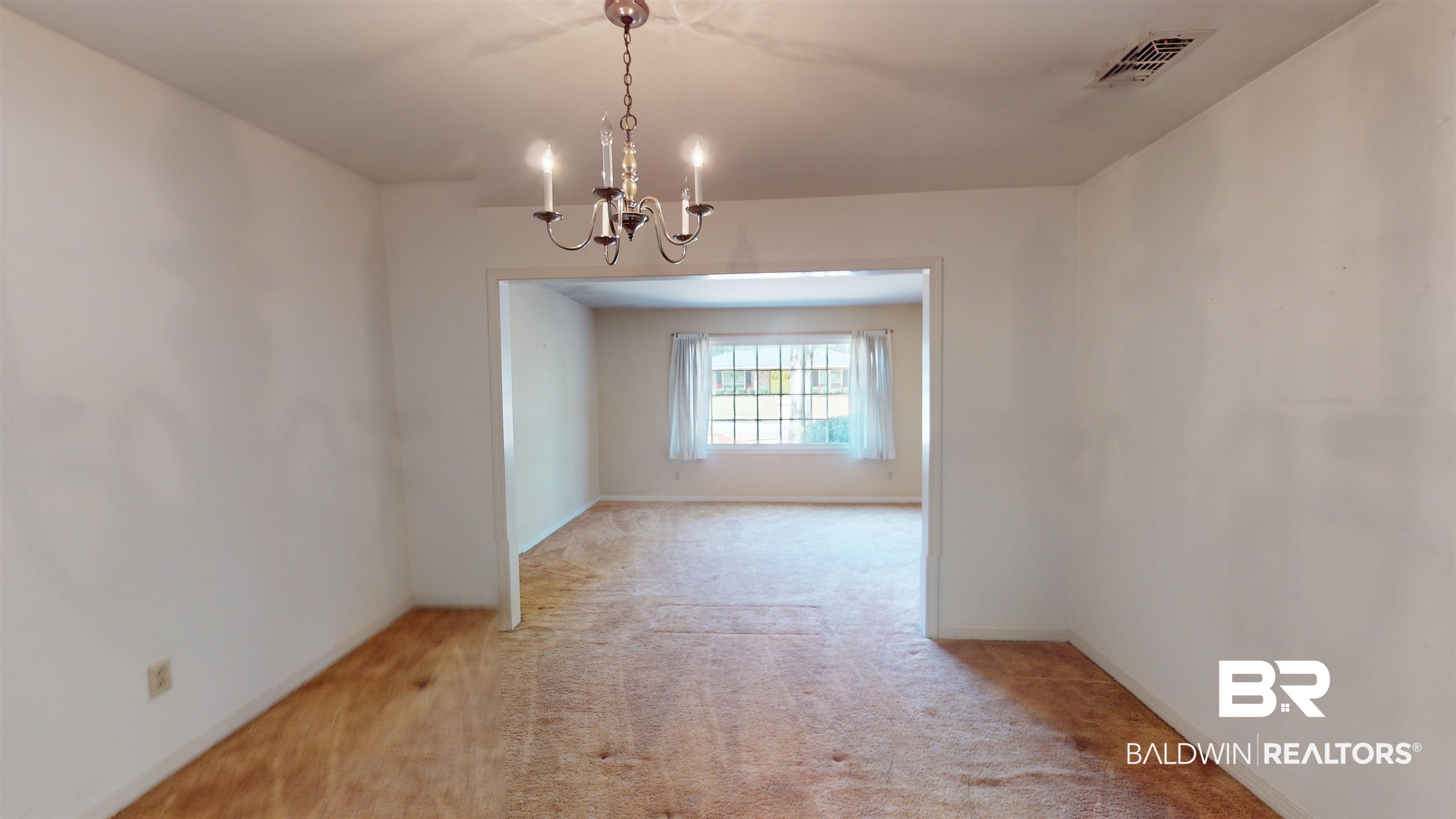 816 Overbey Drive Mobile, AL 36608 - Photo 18 of 27 Carpeted empty room featuring a notable chandelier