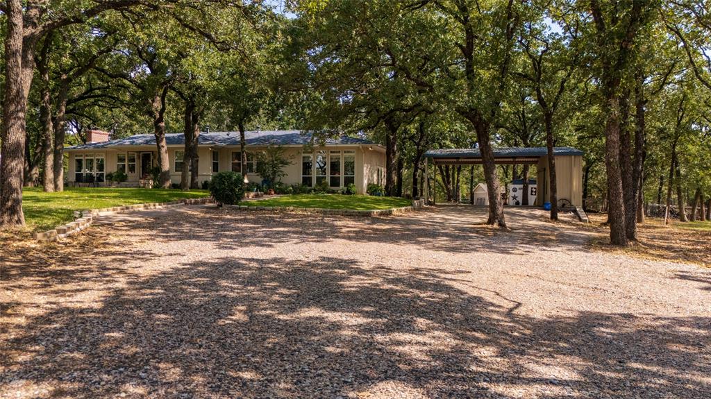 1311 Mount Gilead Road Keller, TX 76262 - Photo 2 of 40 Big oak trees and a long drive. This place feels like home before you even step inside.