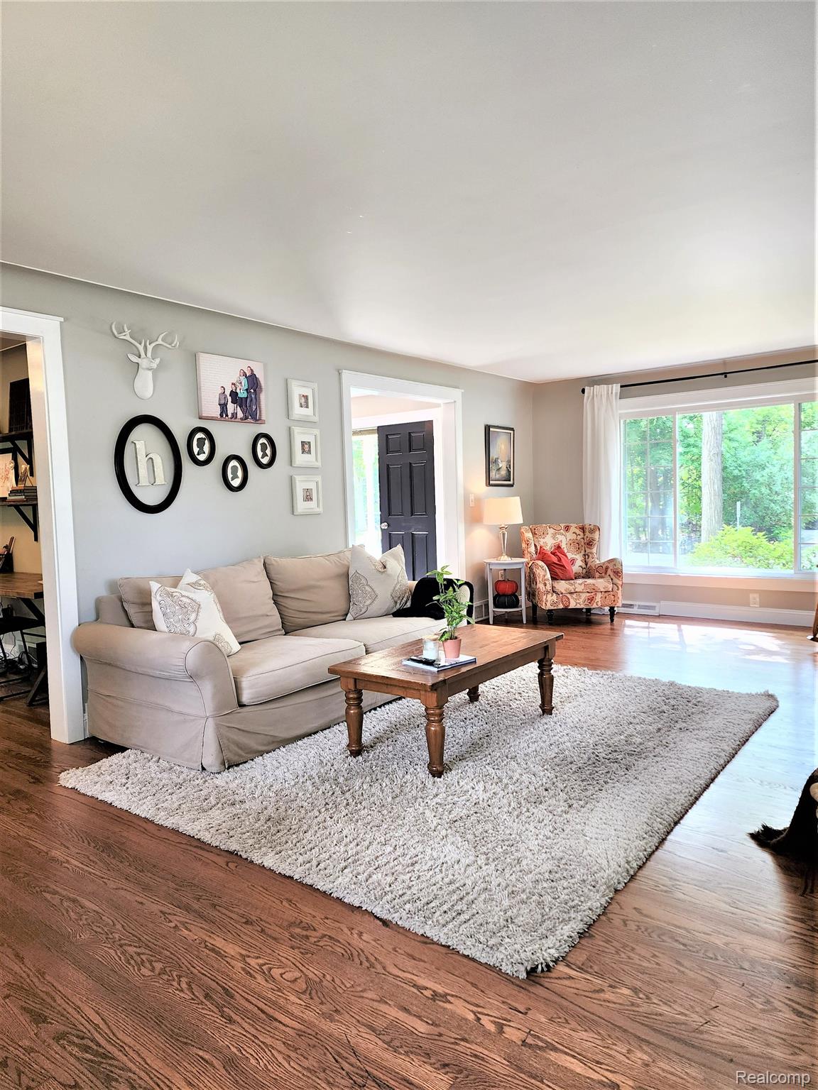 Living room, lg. picture window, & fireplace. 