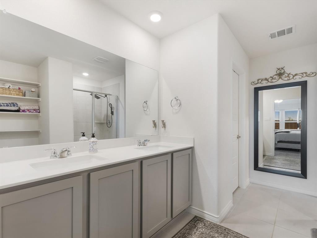 3257 Trails End Road Aubrey, TX 76227 - Photo 13 of 37 a bathroom with a sink double vanity and a mirror