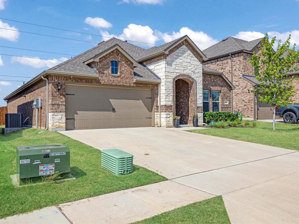 3257 Trails End Road Aubrey, TX 76227 - Photo 2 of 37 a front view of a house with a garden