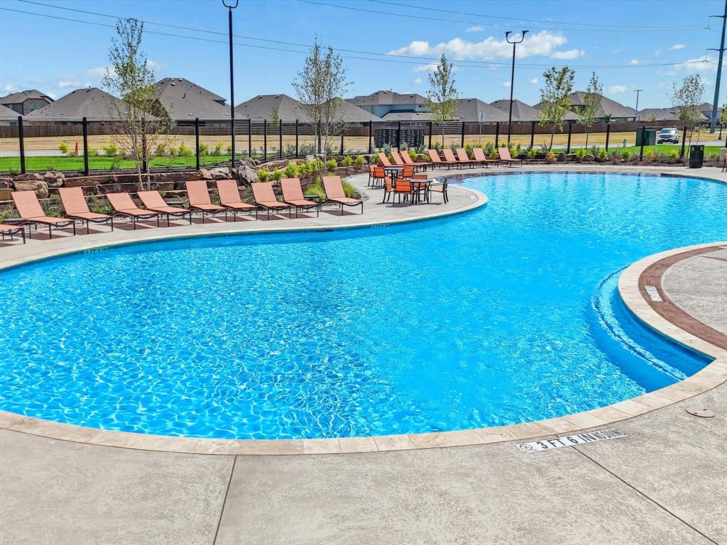 3257 Trails End Road Aubrey, TX 76227 - Photo 28 of 37 a view of a swimming pool with a lawn chairs