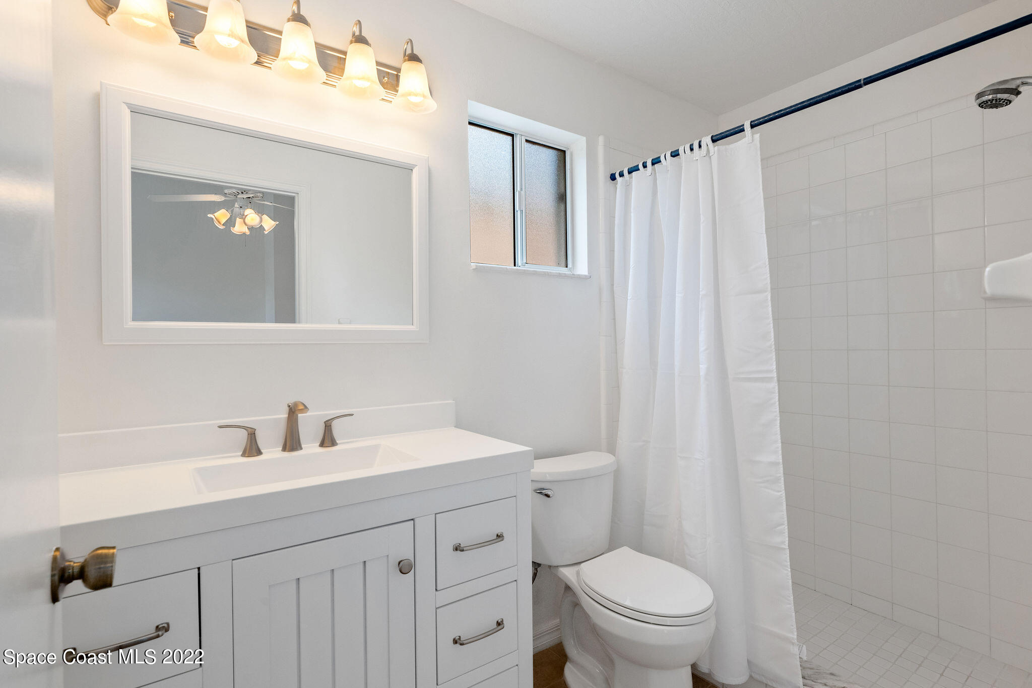 949 South Fork Circle Melbourne, FL 32901 - Photo 14 of 35 a bathroom with a sink a toilet and a mirror