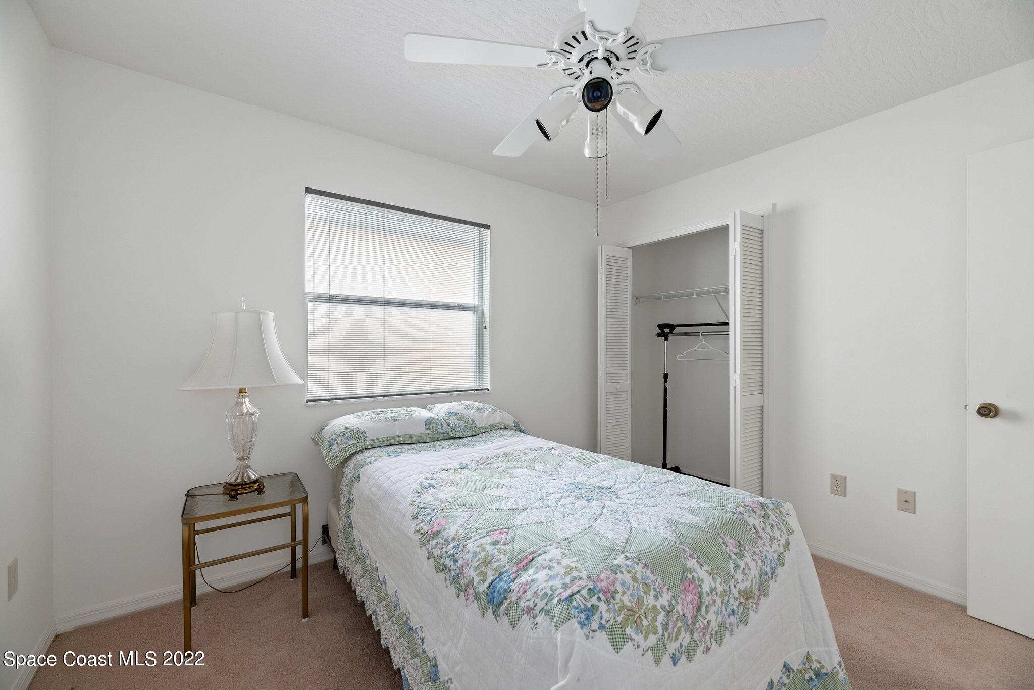 949 South Fork Circle Melbourne, FL 32901 - Photo 16 of 35 a bedroom with a bed and a chandelier