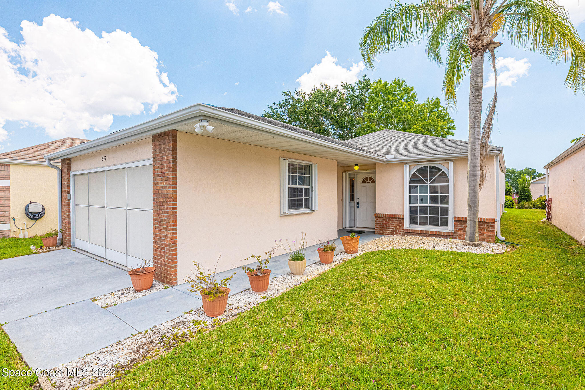 949 South Fork Circle Melbourne, FL 32901 - Photo 2 of 35 a front view of house with yard and trees in the background
