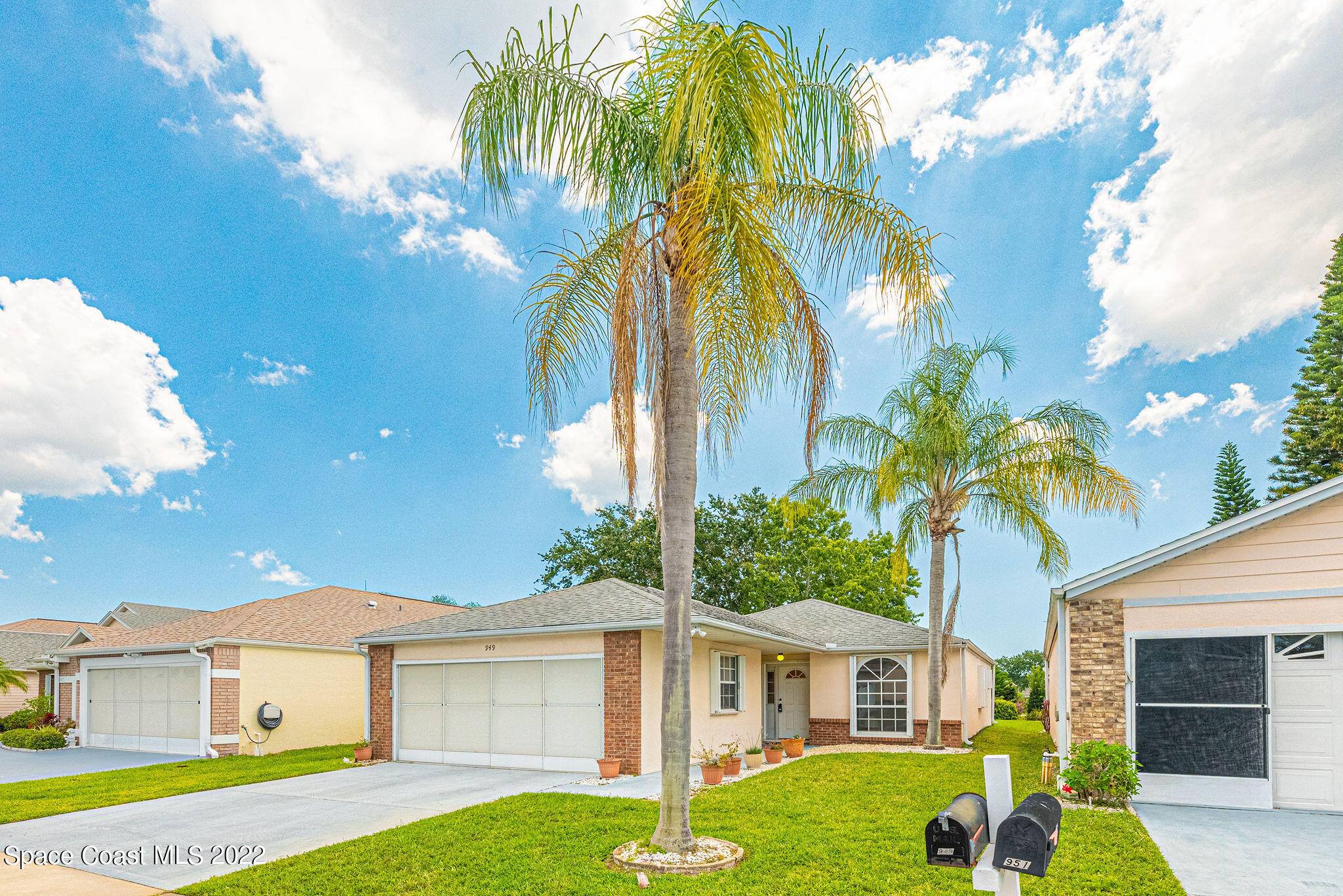 949 South Fork Circle Melbourne, FL 32901 - Photo 3 of 35 a front view of a house with a yard and garage