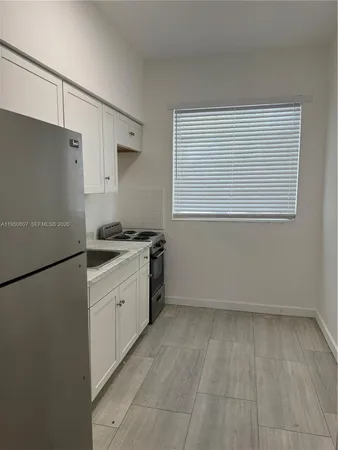 a kitchen that has a sink and a stove