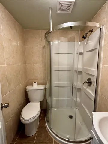 a bathroom with a toilet and a shower