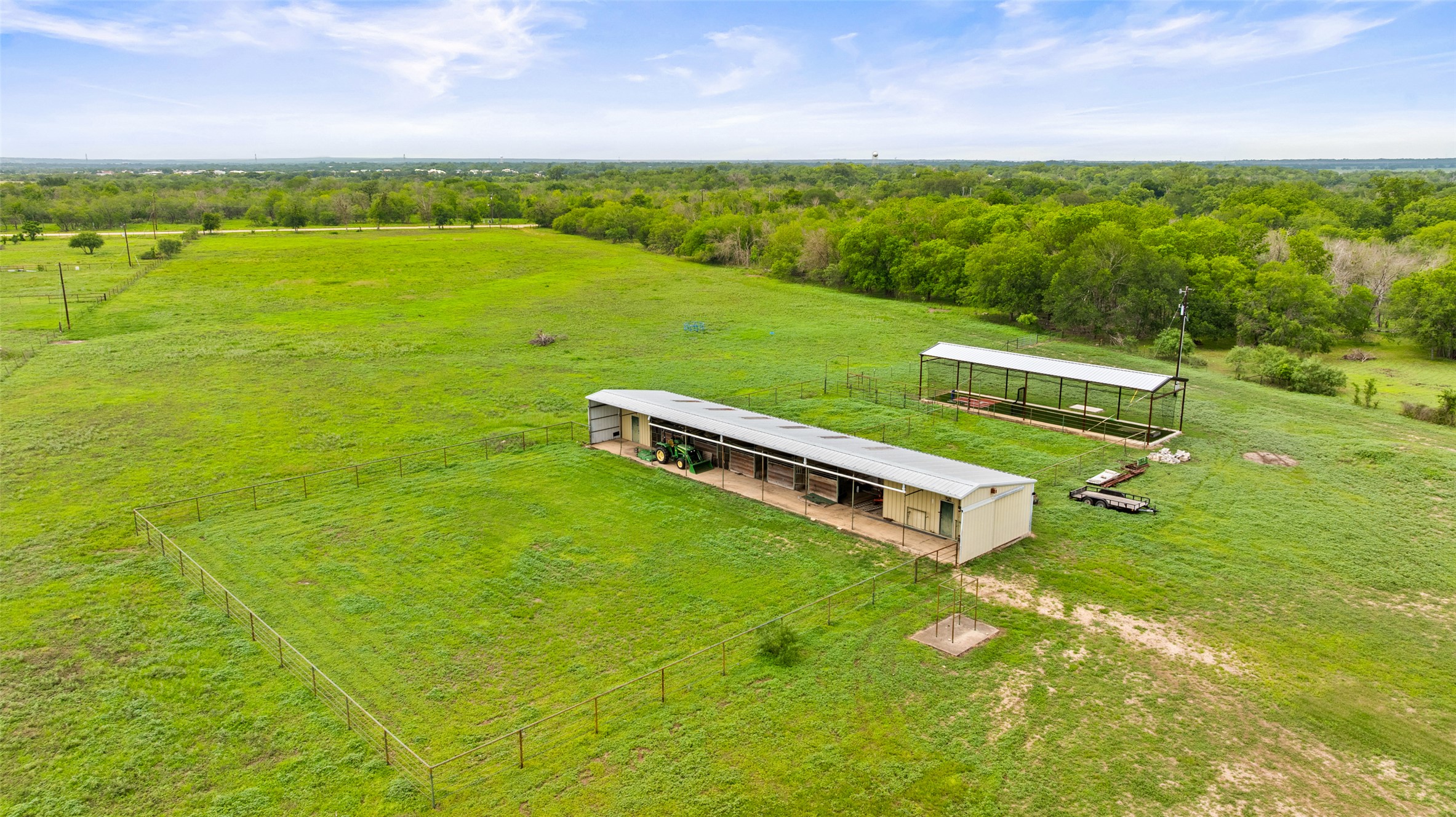 664 Martindale Falls Road Martindale, TX 78655 - Photo 3 of 21 Expansive green pastureland featuring two enclosed structures