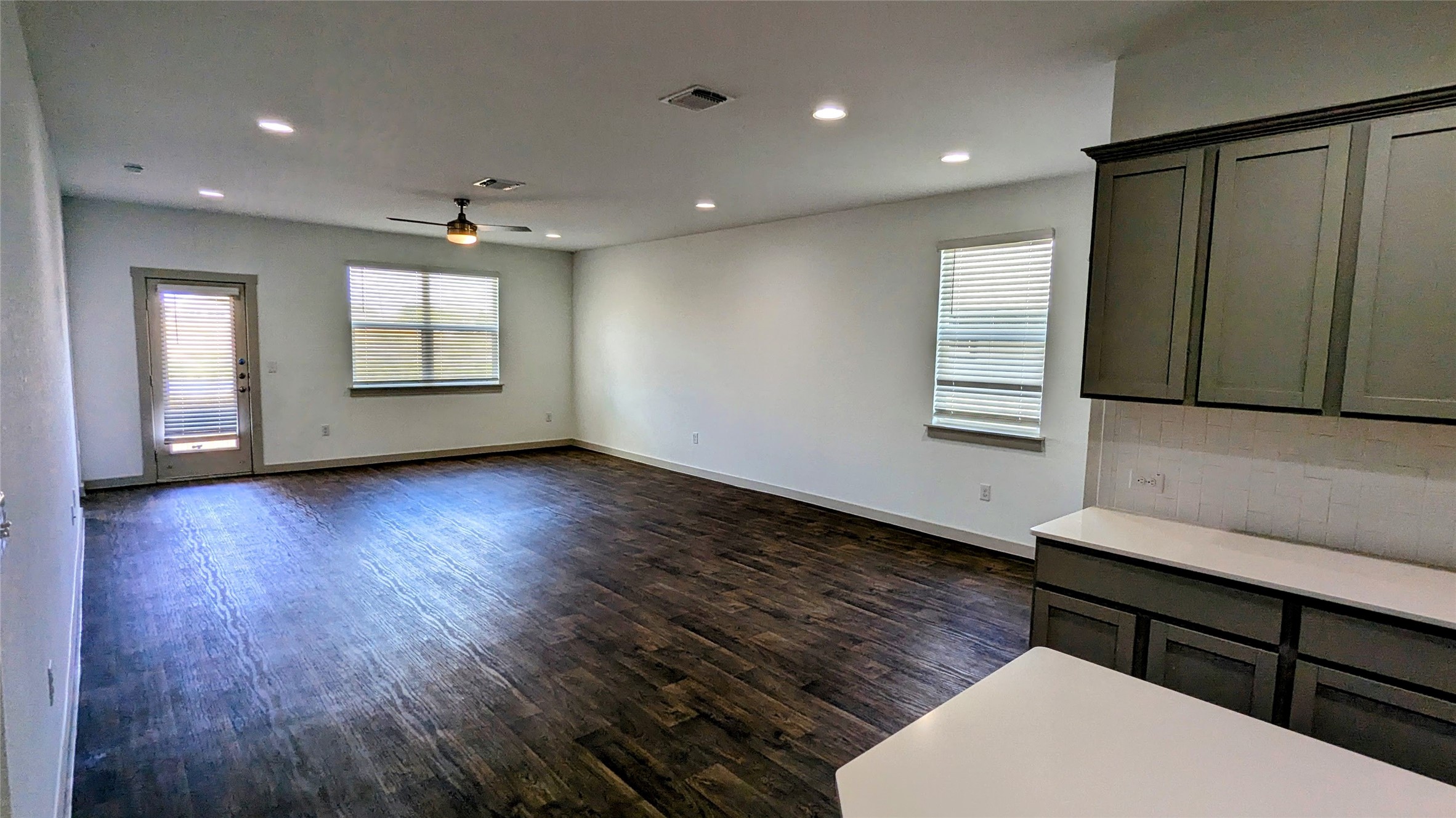 13804 Clerk Street Pflugerville, TX 78660 - Photo 3 of 14 an empty room with wooden floor and windows