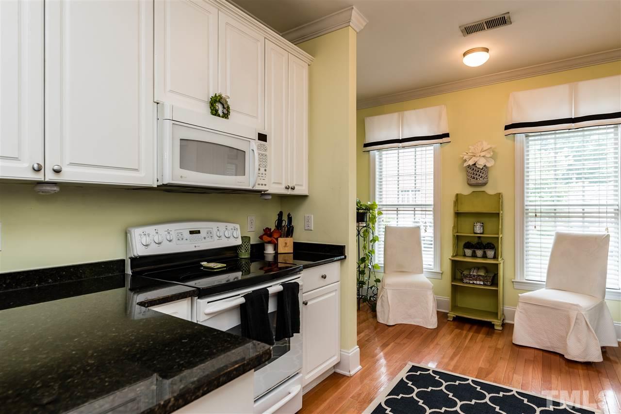 631 Highpark Lane Raleigh, NC 27608 - Photo 8 of 25 a kitchen with stainless steel appliances granite countertop a stove and a microwave