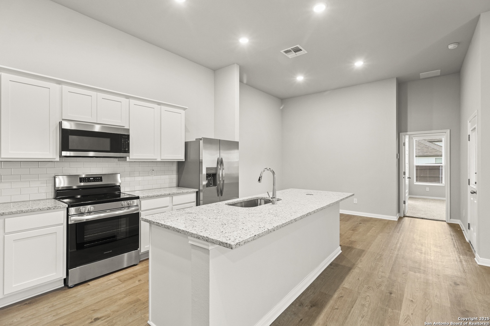 418 Cross Barn Boulevard, Unit B Buda, TX 78610 - Photo 14 of 35 a kitchen with a sink a counter top space stainless steel appliances and cabinets