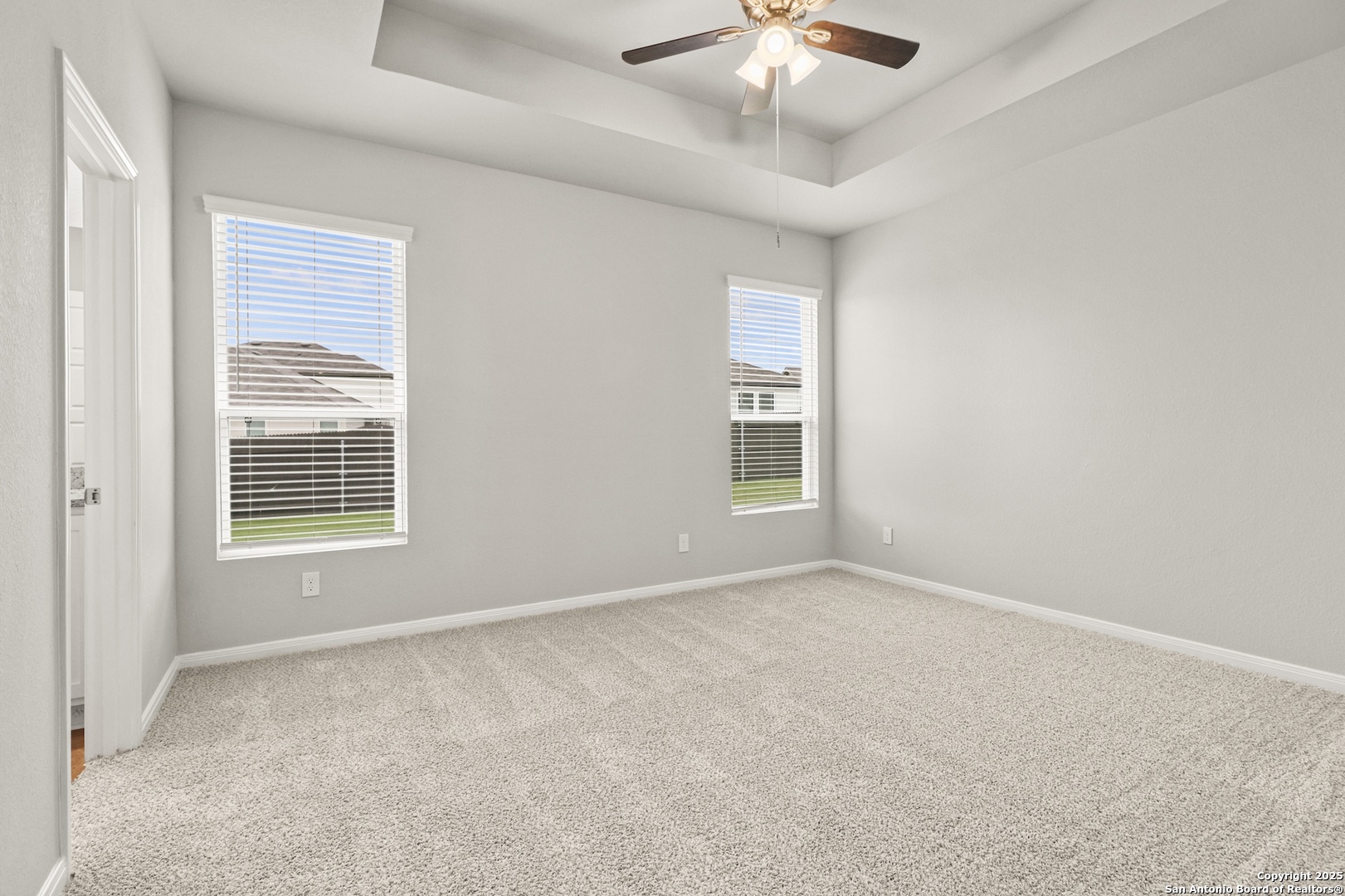 418 Cross Barn Boulevard, Unit B Buda, TX 78610 - Photo 17 of 35 an empty room with windows and fan