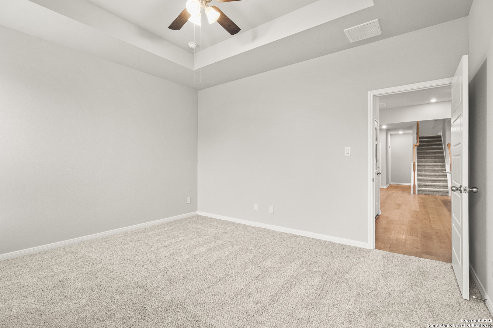 418 Cross Barn Boulevard, Unit B Buda, TX 78610 - Photo 18 of 35 an empty room with a chandelier fan and windows